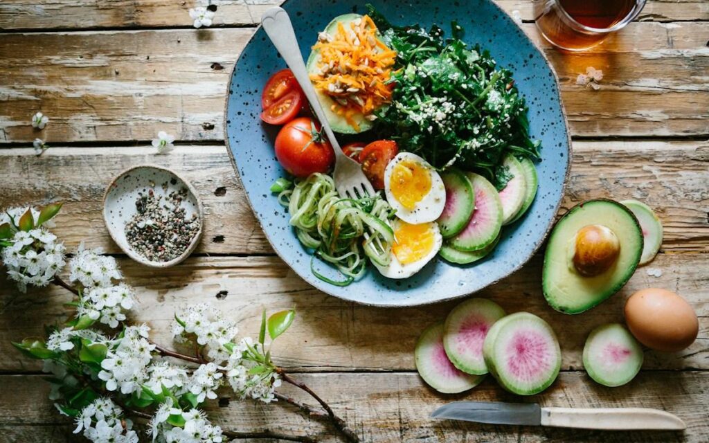 Colorful healthy portioned balanced meal plate with avocado, greens, and protein for weight loss meal plans